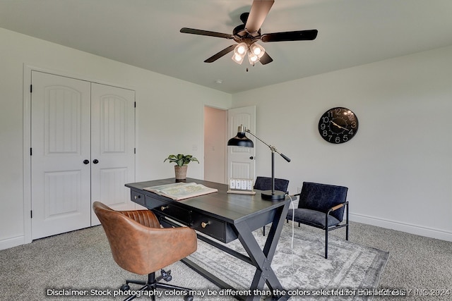 carpeted office space featuring ceiling fan