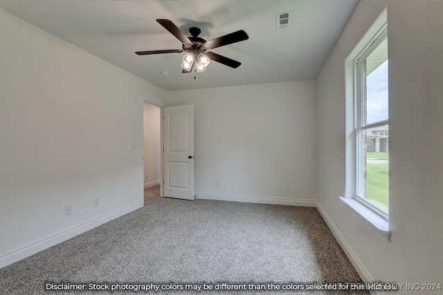 carpeted empty room featuring ceiling fan