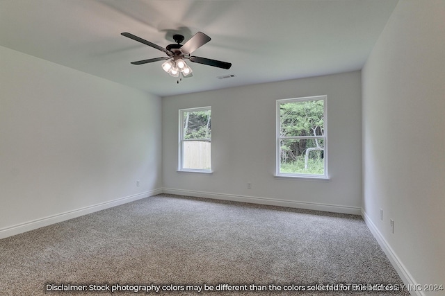 carpeted spare room with ceiling fan