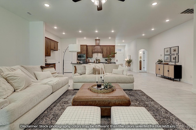 living room featuring ceiling fan and sink