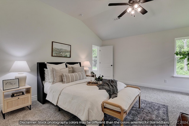 carpeted bedroom with ceiling fan and vaulted ceiling