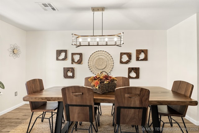 dining space featuring wood-type flooring