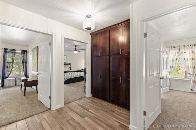 interior space featuring light hardwood / wood-style floors and a textured ceiling