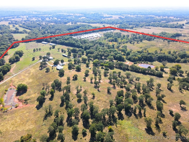 birds eye view of property with a rural view