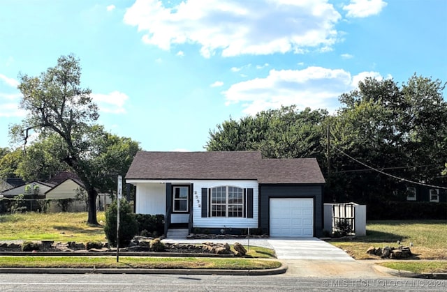 ranch-style house featuring a front yard and a garage