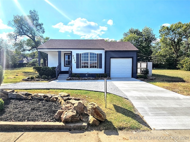 view of front of property with a garage and a front yard