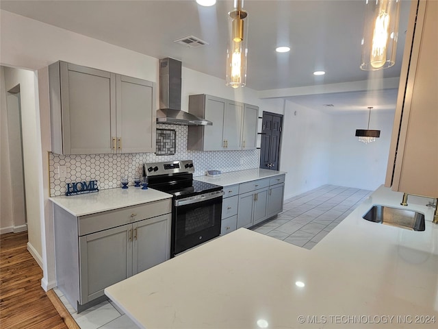 2532 N Martin Luther King Jr Blvd, Tulsa, OK 74106 - kitchen featuring electric range, wall chimney exhaust hood, gray cabinetry, decorative backsplash, and recessed lighting