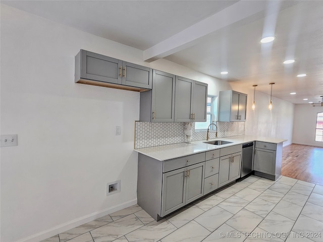 kitchen with pendant lighting, a wealth of natural light, sink, and gray cabinetry