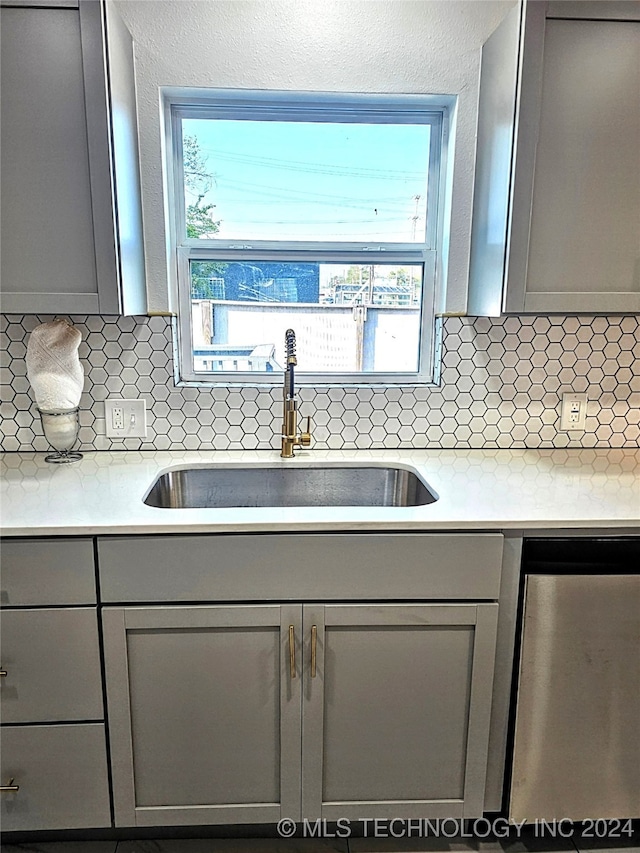 2532 N Martin Luther King Jr Blvd, Tulsa, OK 74106 - kitchen with gray cabinetry, a sink, decorative backsplash, and plenty of natural light