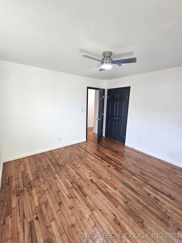 empty room with ceiling fan and hardwood / wood-style floors