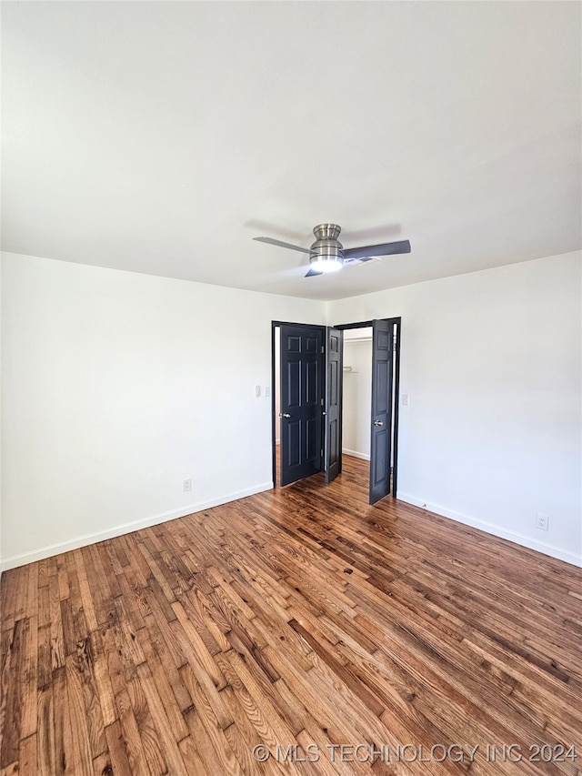 unfurnished bedroom with ceiling fan and hardwood / wood-style floors