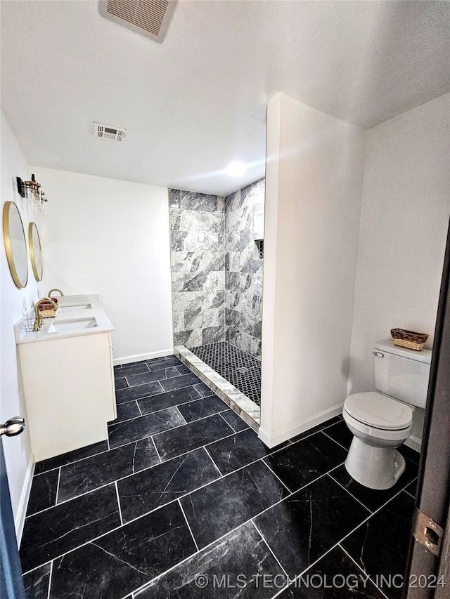 bathroom featuring vanity, a shower, and toilet