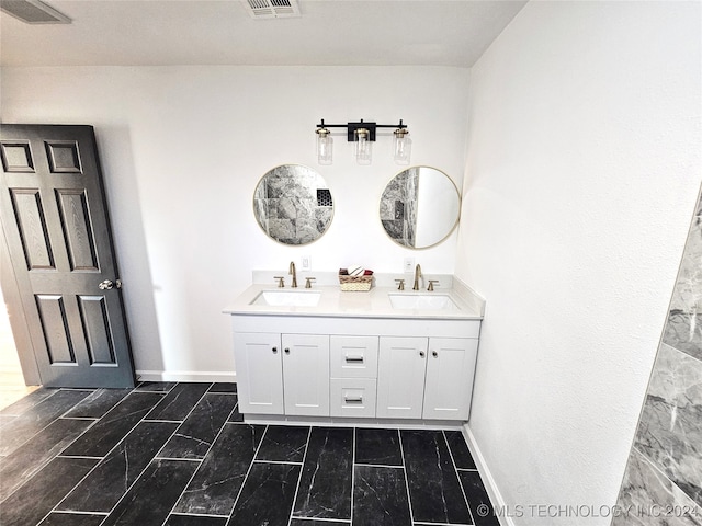 2532 N Martin Luther King Jr Blvd, Tulsa, OK 74106 - bathroom with baseboards, double vanity, and marble look tiles