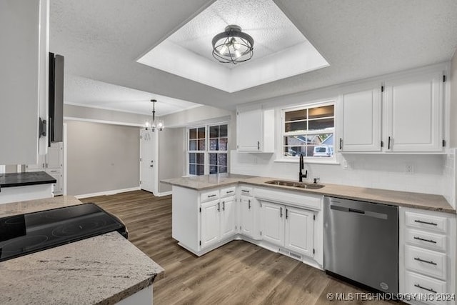 kitchen with stainless steel dishwasher, white cabinets, sink, kitchen peninsula, and a textured ceiling