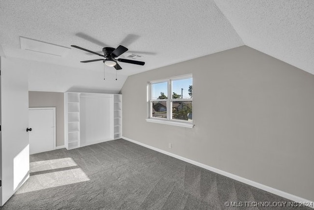 bonus room with carpet flooring, vaulted ceiling, and a textured ceiling