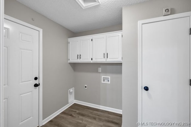 clothes washing area featuring hookup for an electric dryer, a textured ceiling, dark wood-type flooring, cabinets, and hookup for a washing machine