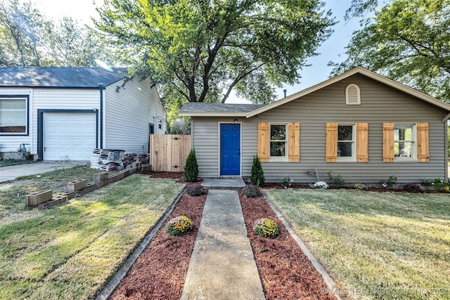 ranch-style house with a front yard and a garage