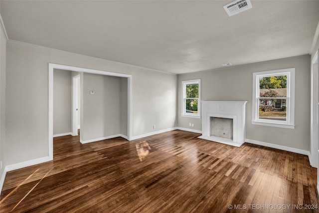 unfurnished living room with dark hardwood / wood-style floors and a healthy amount of sunlight