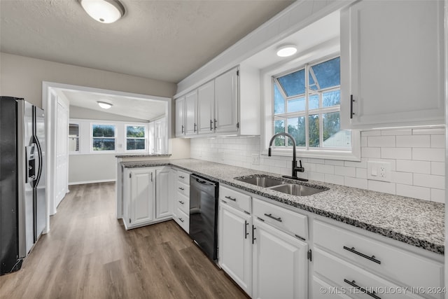 kitchen featuring dishwasher, white cabinets, stainless steel refrigerator with ice dispenser, and sink