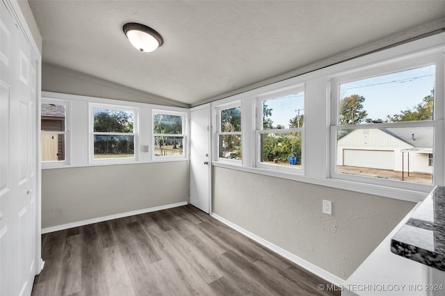 unfurnished sunroom with lofted ceiling and a healthy amount of sunlight