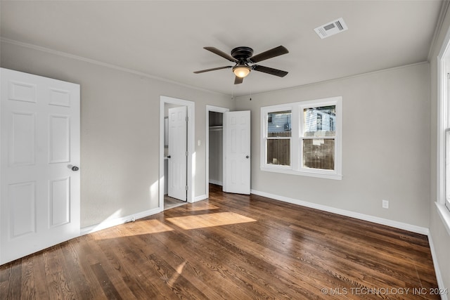 unfurnished bedroom with crown molding, dark hardwood / wood-style flooring, and ceiling fan