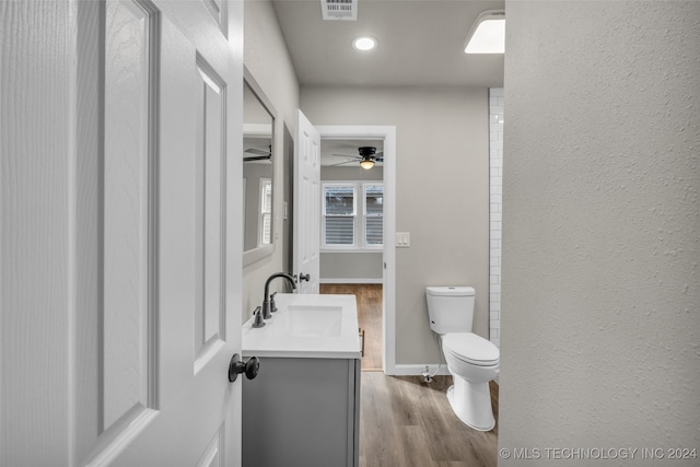 bathroom featuring ceiling fan, vanity, toilet, and wood-type flooring