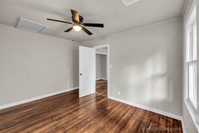 empty room featuring ornamental molding, dark hardwood / wood-style flooring, and ceiling fan