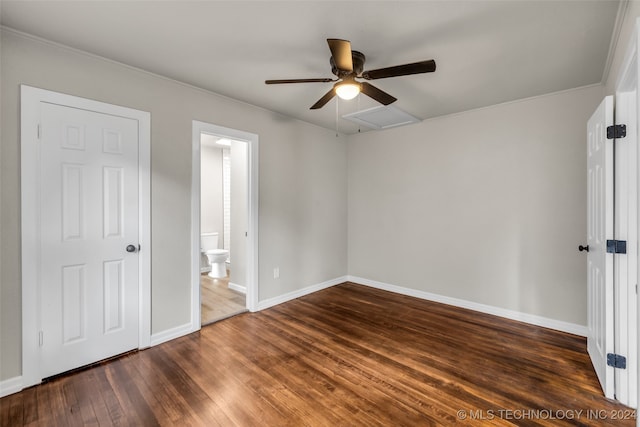 unfurnished bedroom with ceiling fan, ensuite bath, dark hardwood / wood-style floors, and ornamental molding