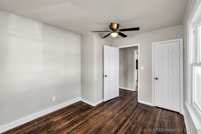 unfurnished bedroom featuring ceiling fan, ornamental molding, and dark wood-type flooring