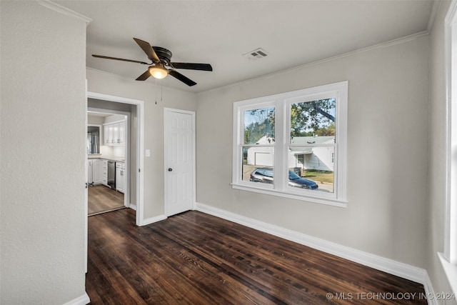 spare room featuring crown molding, dark hardwood / wood-style flooring, and ceiling fan