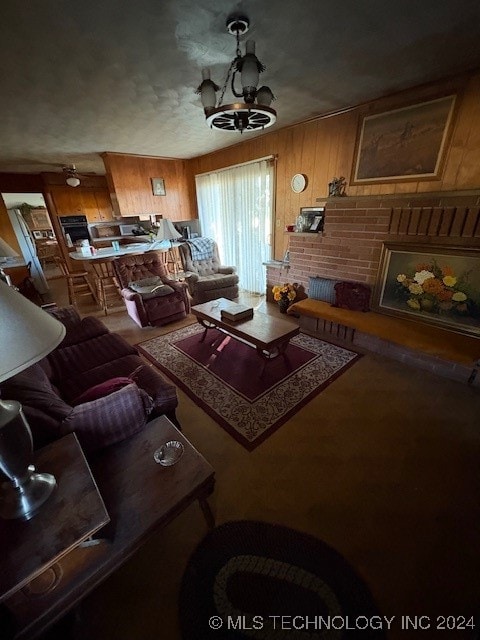 living room with a notable chandelier and wooden walls