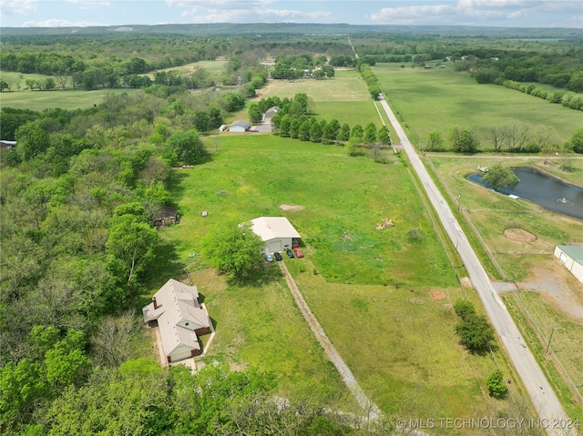 birds eye view of property with a rural view and a water view