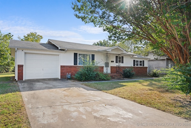 ranch-style home featuring a front yard and a garage