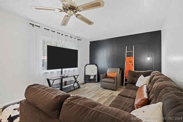 living room featuring ceiling fan and hardwood / wood-style floors