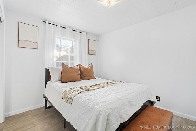 bedroom with wood-type flooring