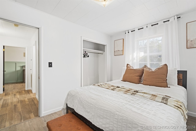 bedroom with wood-type flooring and a closet