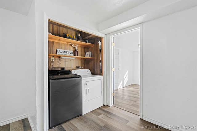 laundry area featuring light hardwood / wood-style floors and washer and dryer