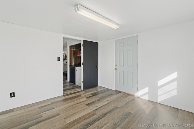 unfurnished room with hardwood / wood-style flooring