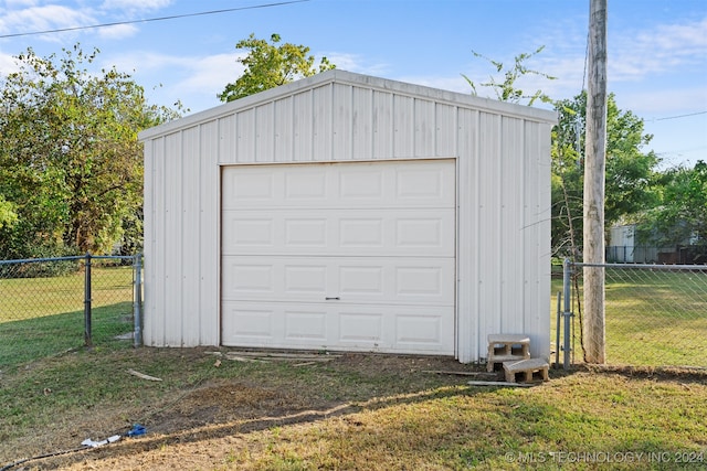 garage with wooden walls and a lawn