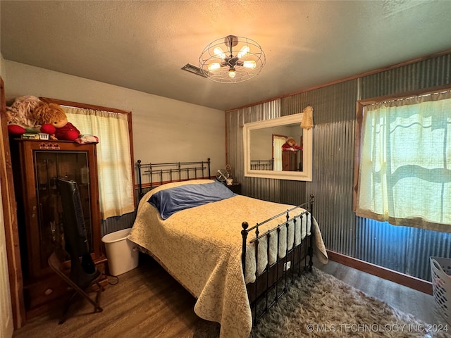 bedroom featuring a textured ceiling and hardwood / wood-style floors