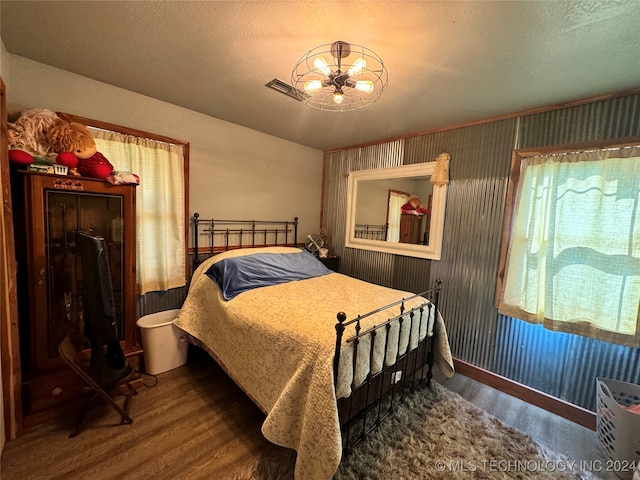 bedroom with wood-type flooring and a textured ceiling