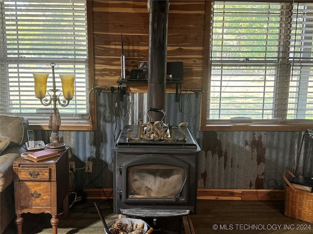 details with wooden walls and a wood stove