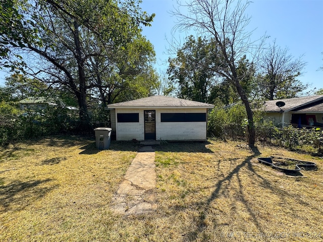 view of outbuilding featuring a lawn