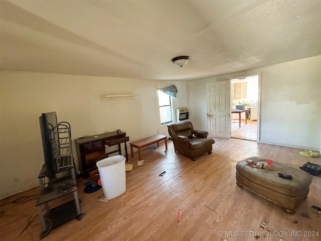 sitting room with lofted ceiling and light wood-type flooring