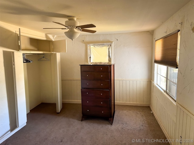 unfurnished bedroom featuring a closet, carpet flooring, and ceiling fan