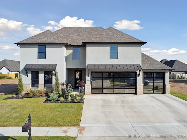 view of front of home featuring a front lawn and a garage