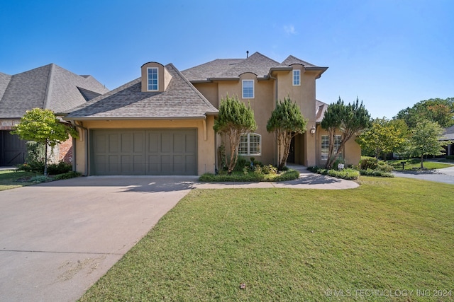 french country inspired facade with a front yard and a garage