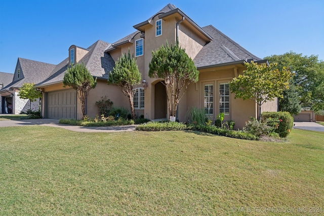 view of front of home with a front lawn and a garage