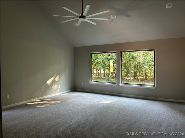 empty room with lofted ceiling, carpet, ceiling fan, and plenty of natural light