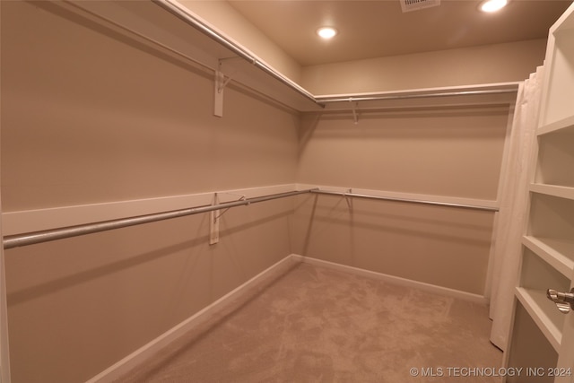 walk in closet featuring carpet flooring